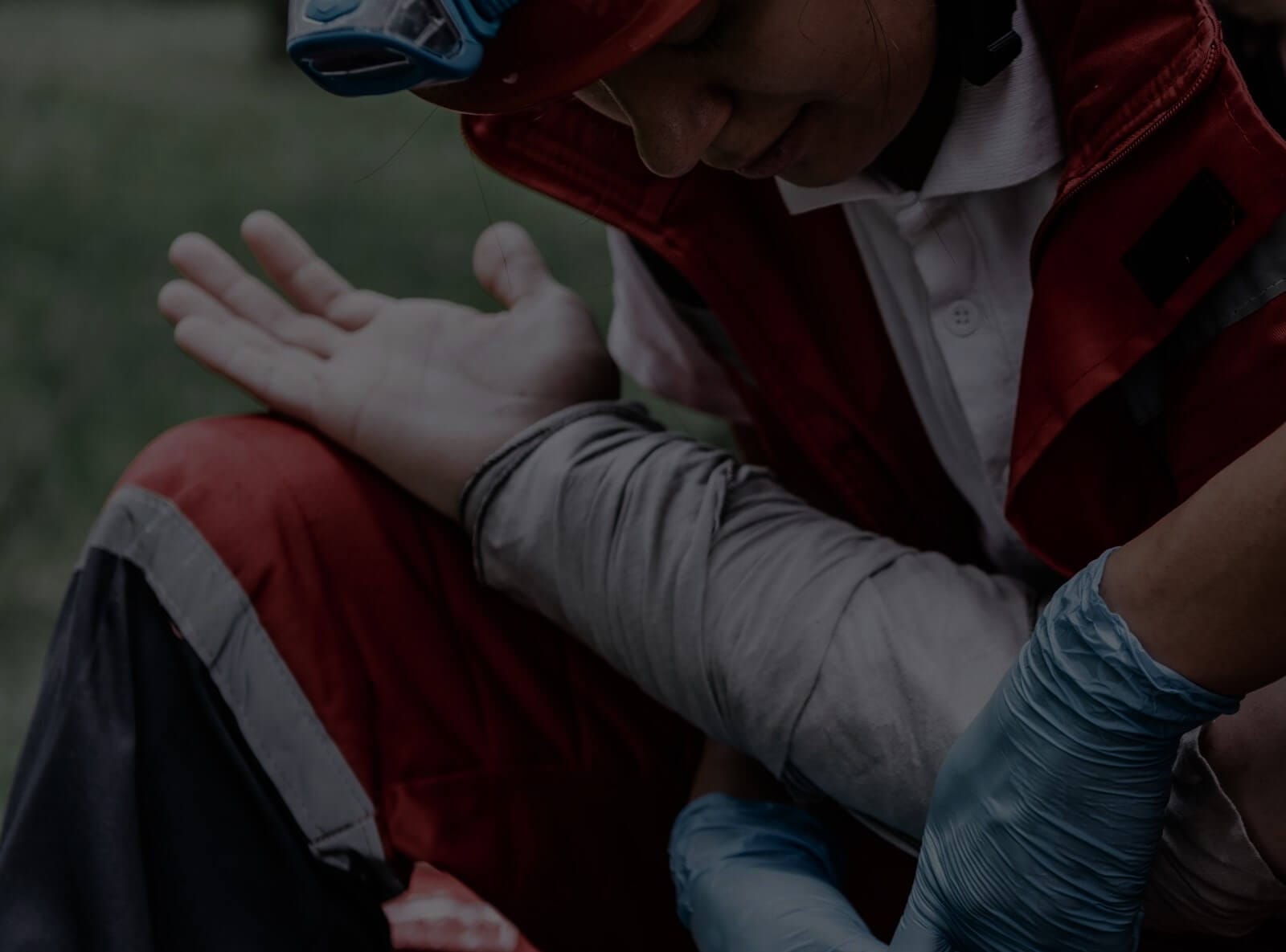First responder applies bandage to third-degree burns on patient’s forearm.