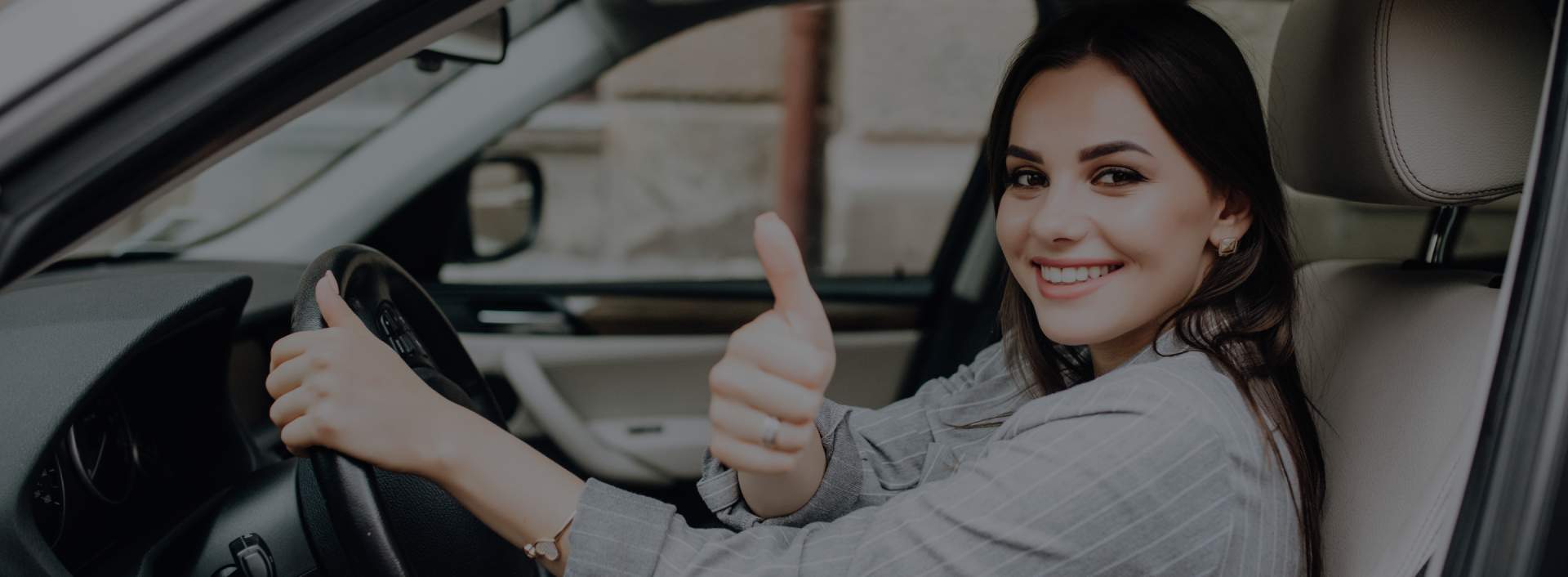 Michigan woman gestures thumbs up from driver's seat after getting her license reinstated.