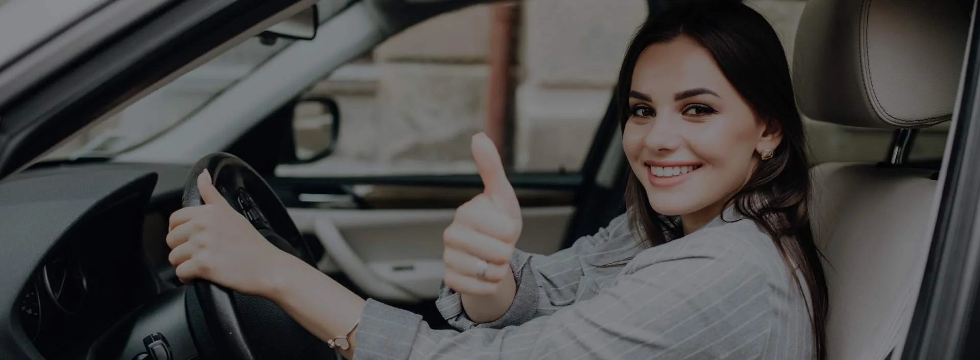Michigan woman gestures thumbs up from driver's seat after getting her license reinstated.