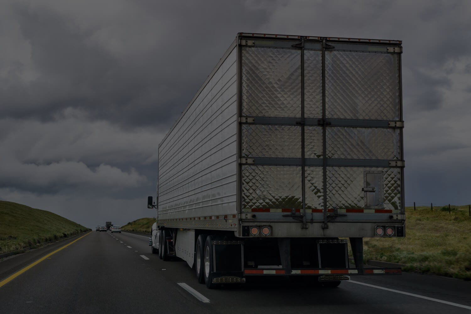 Rear view of tractor-trailer traveling down the interstate in Michigan